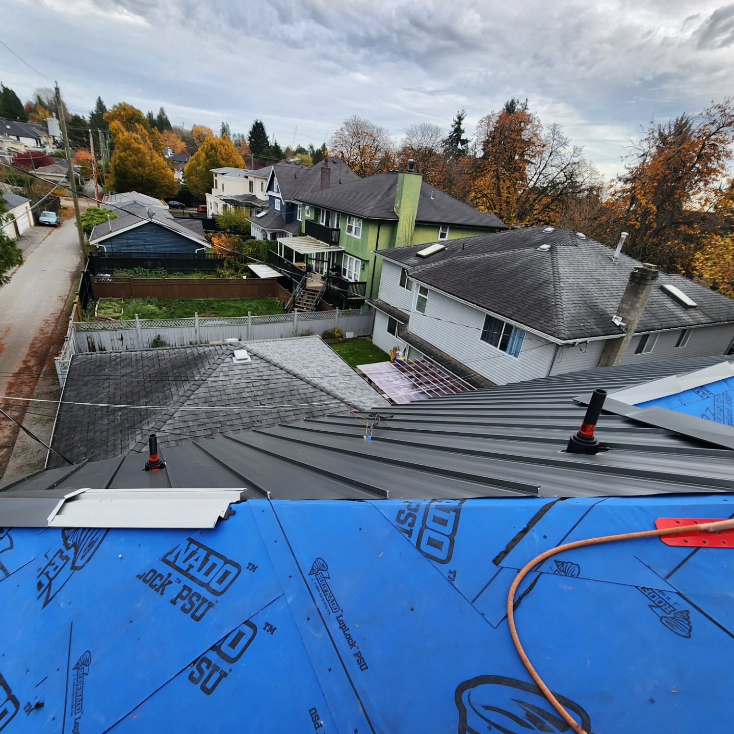 Sheet metal L-flashing for deck ledger in Mission BC